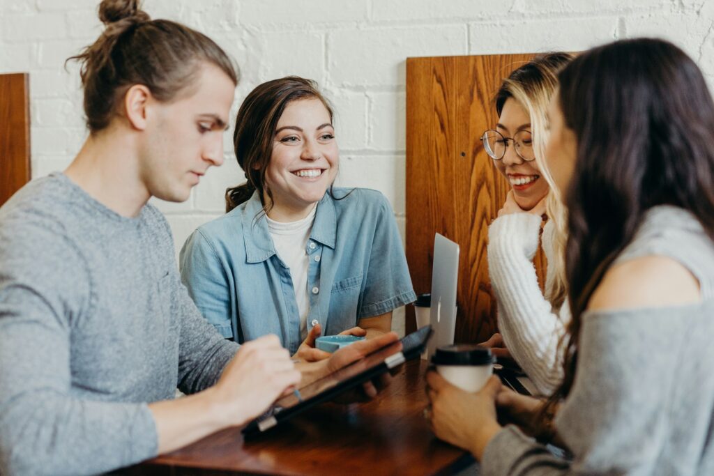 digital marketing team discussing lead nurturing techniques while reviewing analytics on a phone